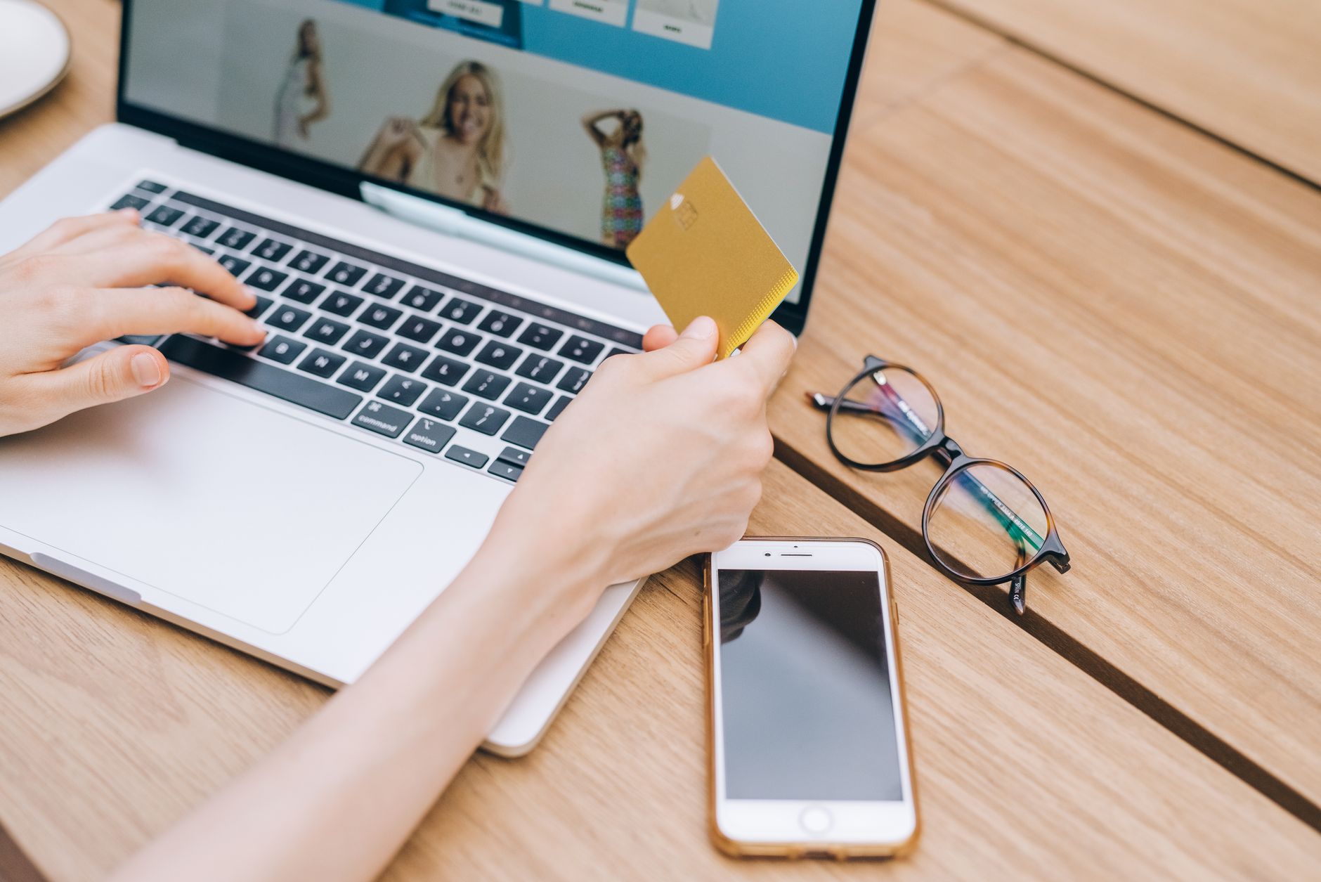 Person completing an online checkout with a credit card on a laptop